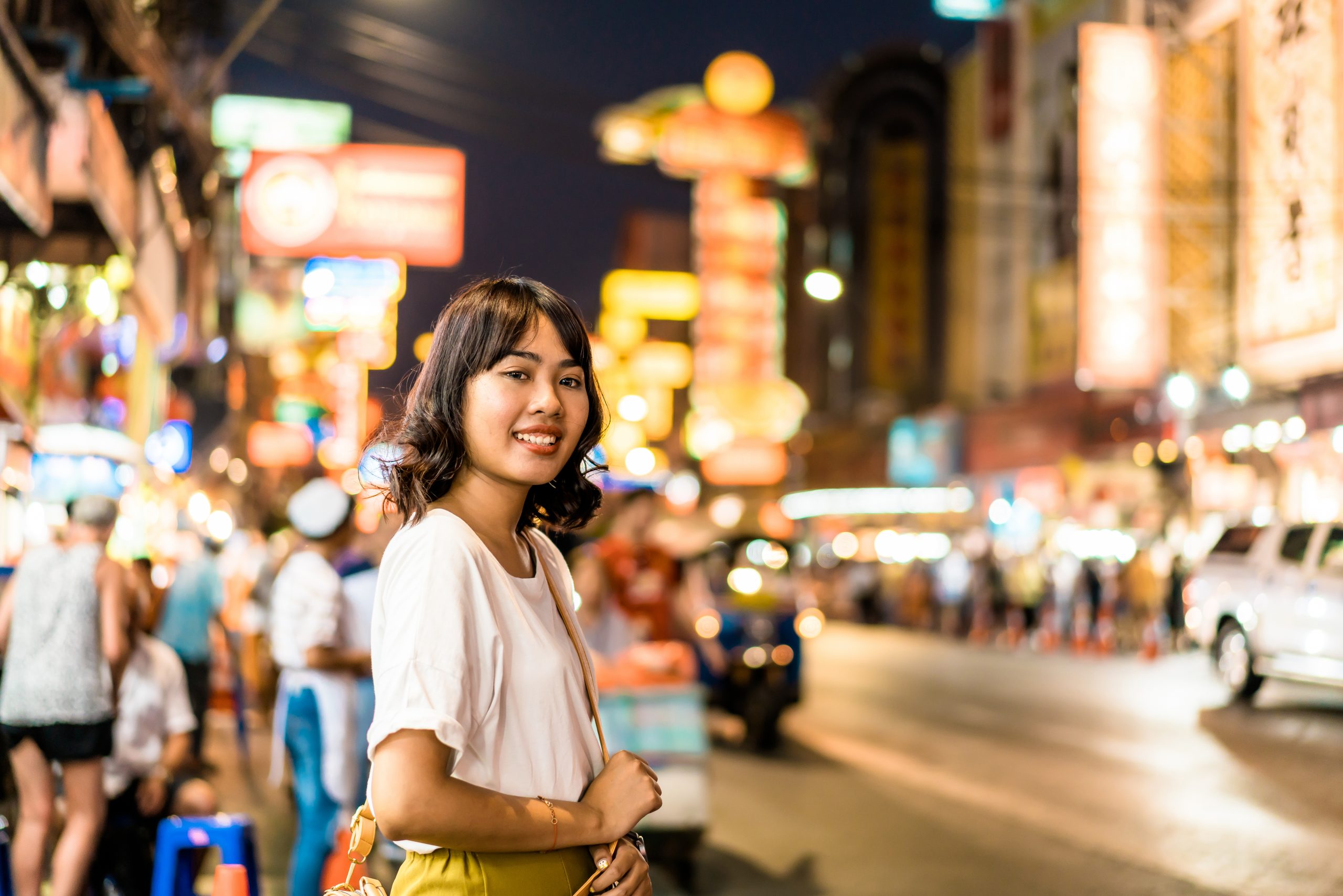 Happy Young Asian Woman Traveler with view at China Town in Bangkok, Thailand